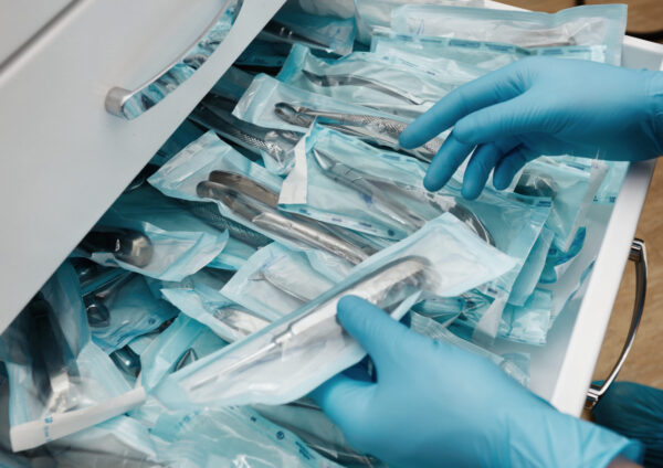 Medical laboratory technician holding a set of sterile disposable instruments